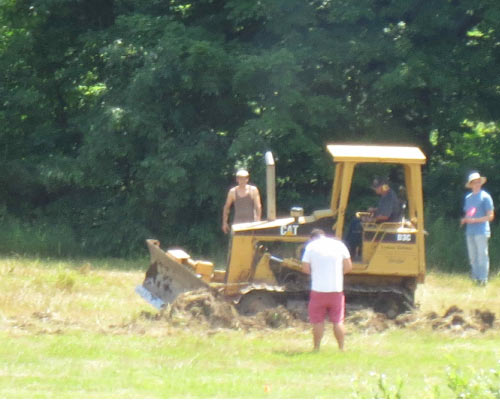 Bulldozer making water harvesting earthworks.